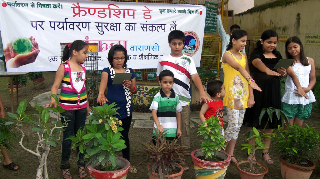 Oath taken by children on Friendship Day with plants and tree.