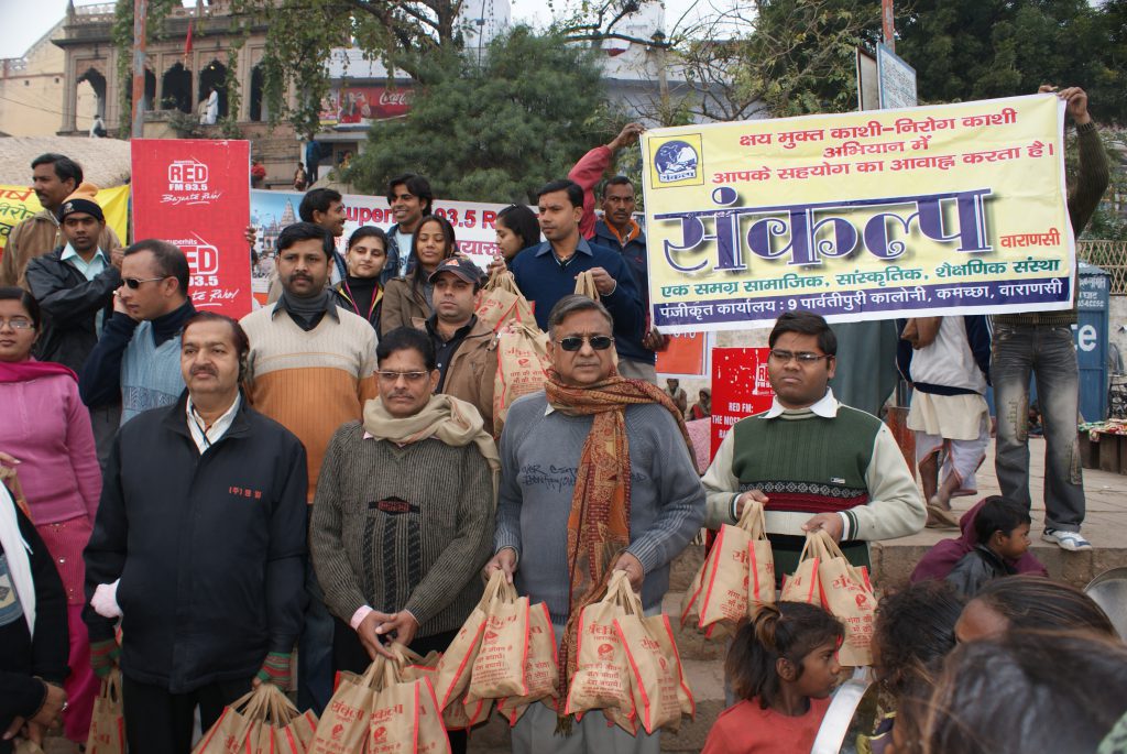 Distribution of food and fruit among needy peoples On occasion of Makarsankranti at ganga ghat.