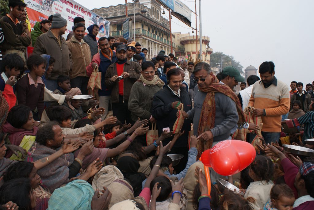 Distribution of food and fruit among needy peoples  On occasion of Makarsankranti at ganga ghat.