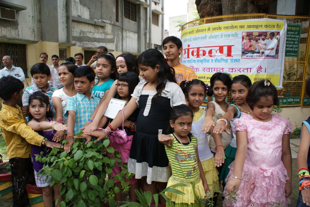 Oath taken by children on Friendship Day with plants and tree.