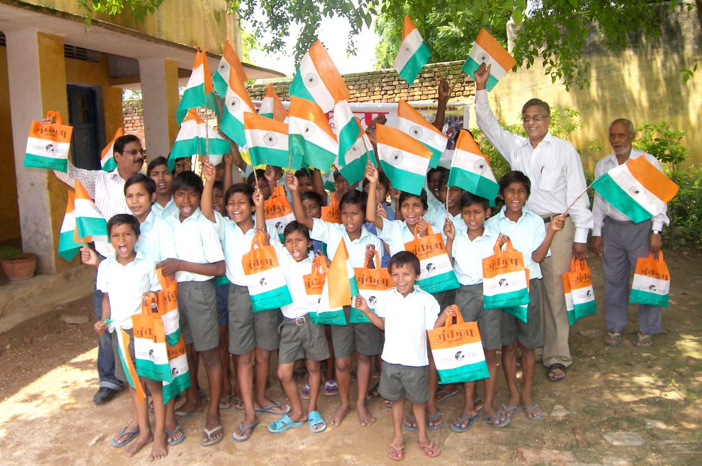 Distribution of cloth bag instead of plastic flag on occasion  of Republic Day among the children of schools.